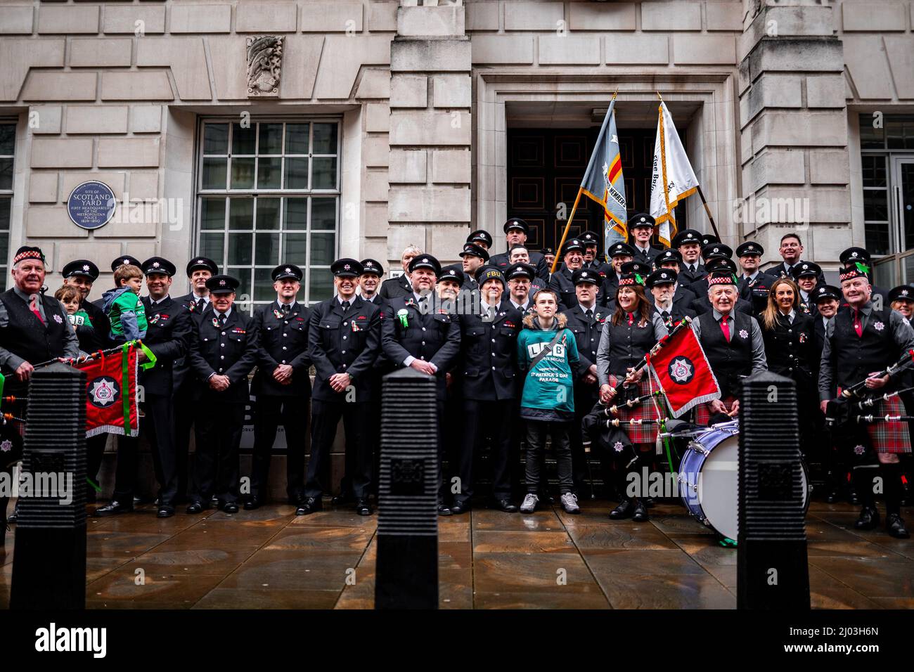 Members of the Fire Brigades Union outside New Scotland Yard during St Patrick's Parade, Whitehall, London, 13 March 2022 Stock Photo