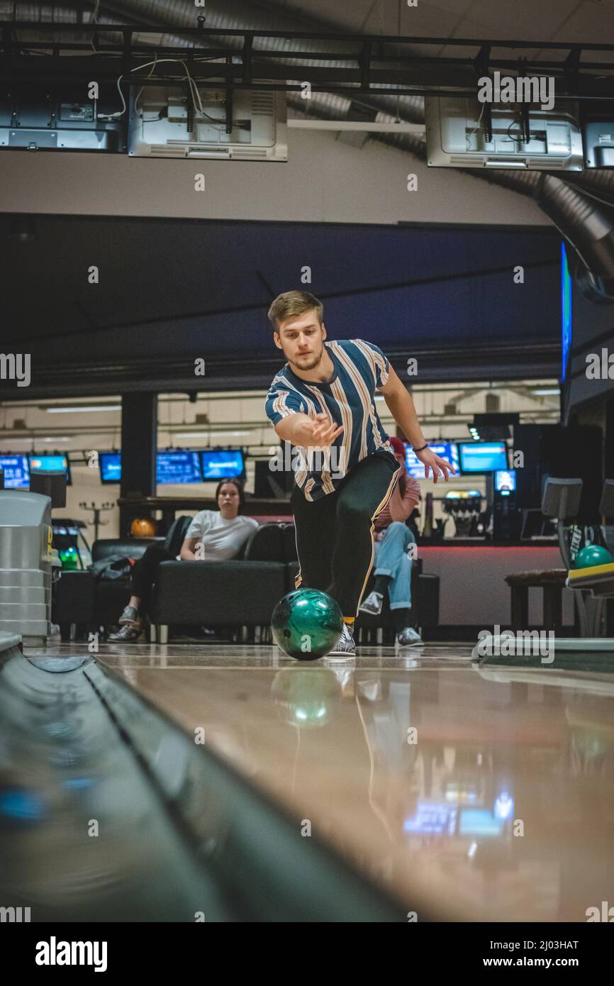 Professional bowler throws his throw and is in position to watch his