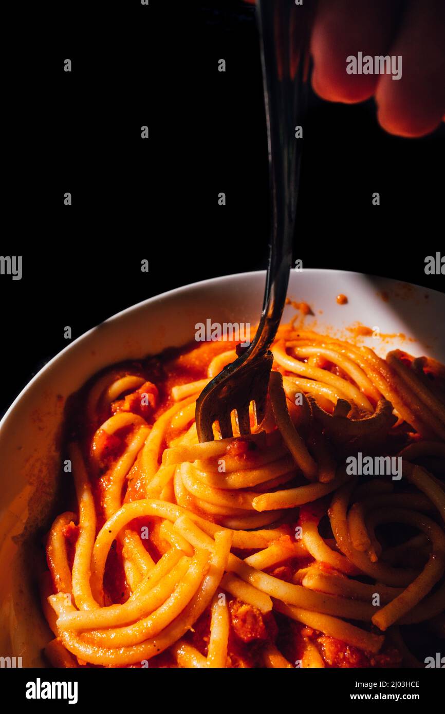 fork twirling Bucatini, spaghetti pasta Stock Photo Alamy
