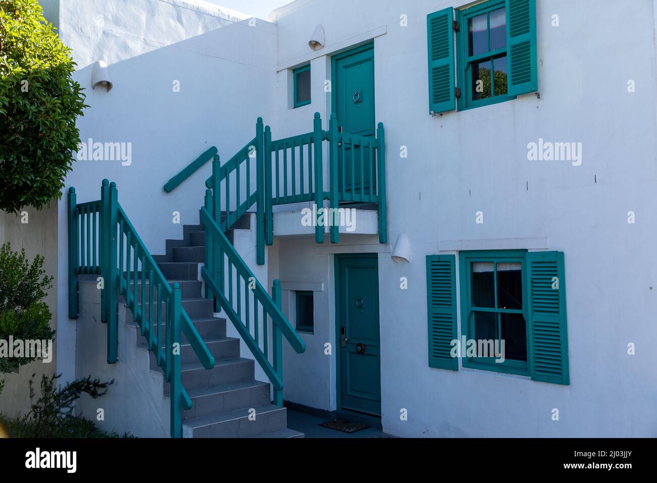 Greek style pastel coloured doors, windows and stairs at Club Mykonos resort in South Africa Stock Photo