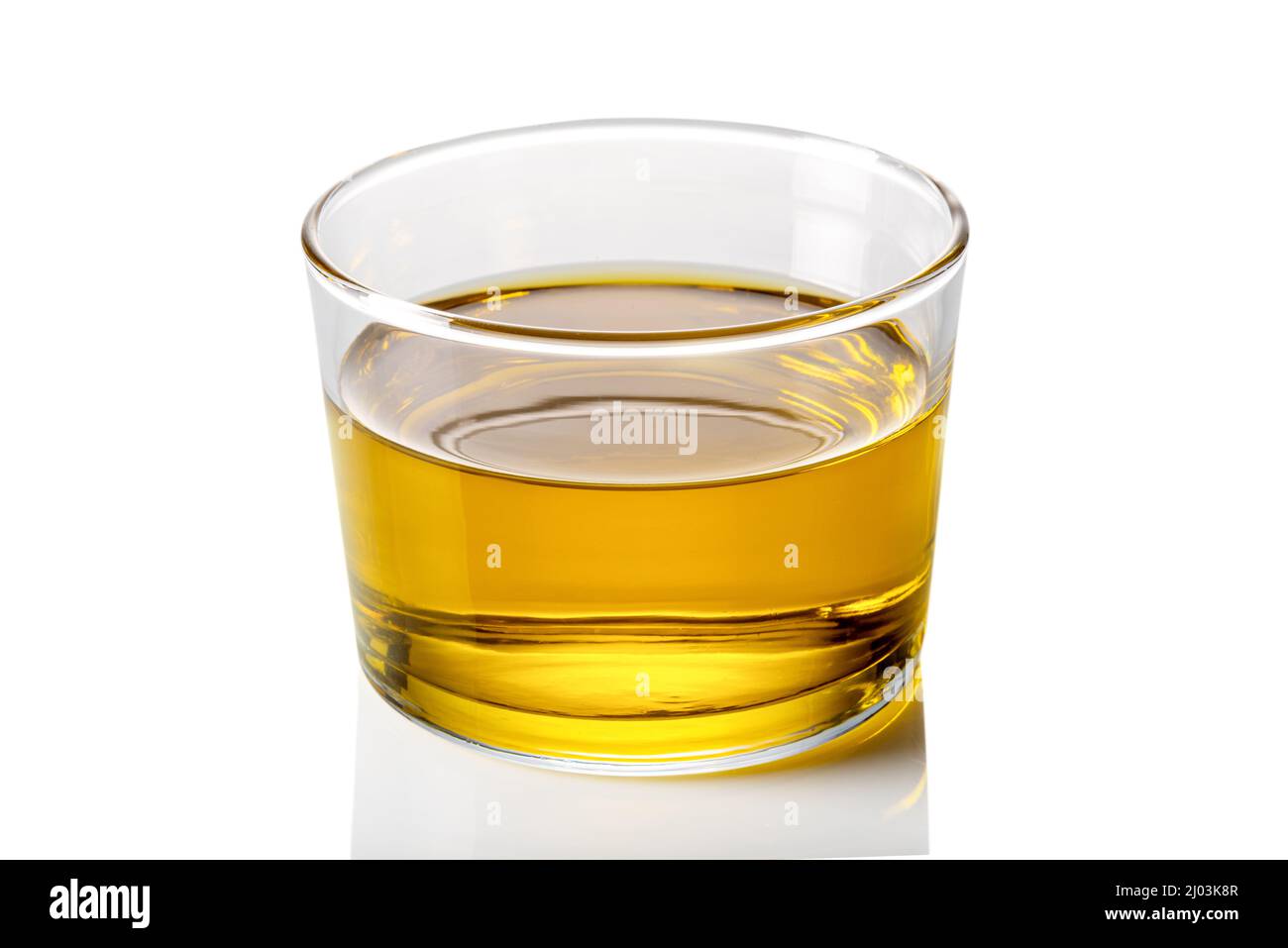 Extra virgin olive oil in glass cup on white background, clipping path ...