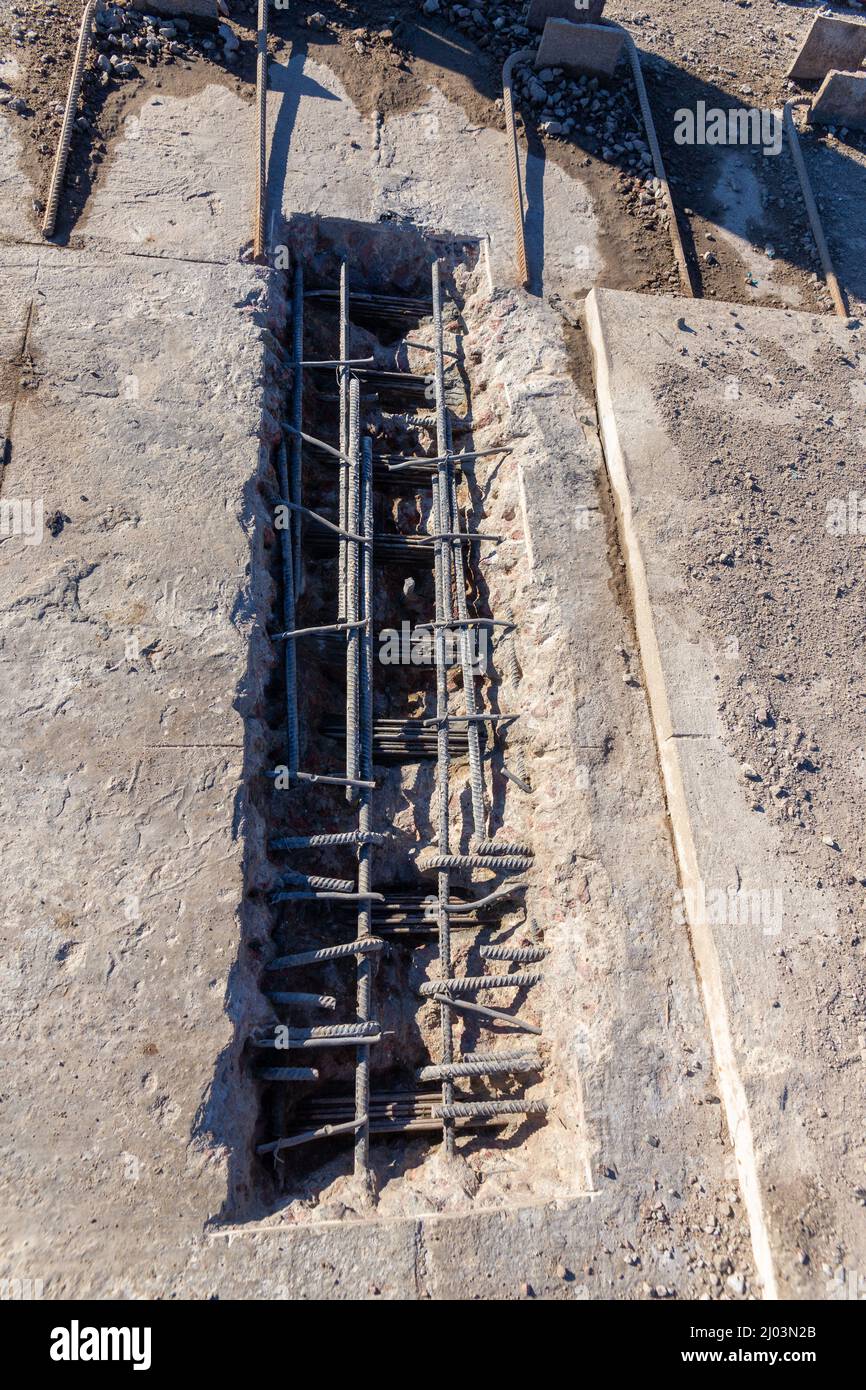 Test section of the supporting structure of the bridge to assess the level of wear of the reinforcement and the need for restoration Stock Photo