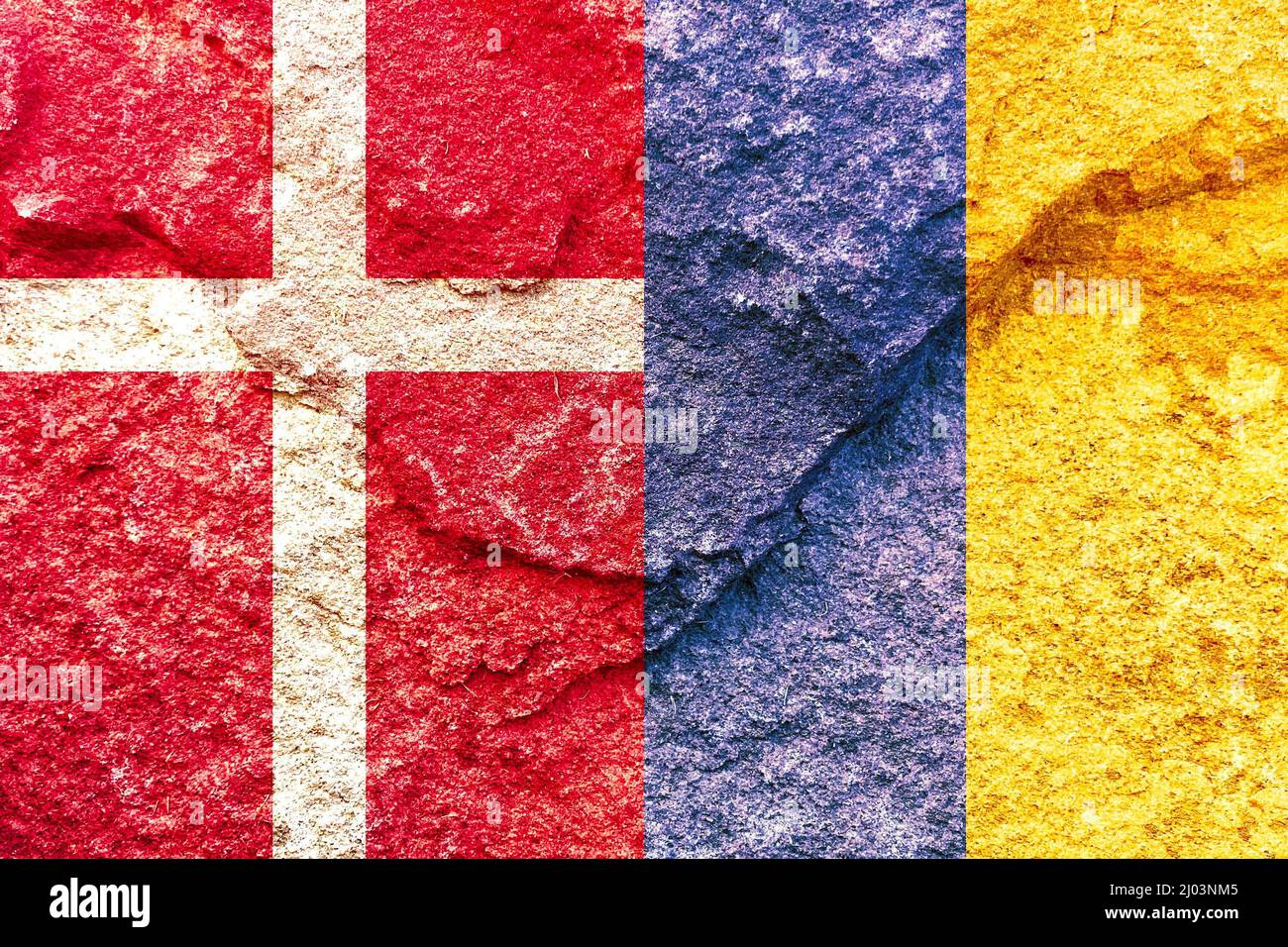 Denmark and Ukraine vertical national flags isolated together on solid rock wall Stock Photo