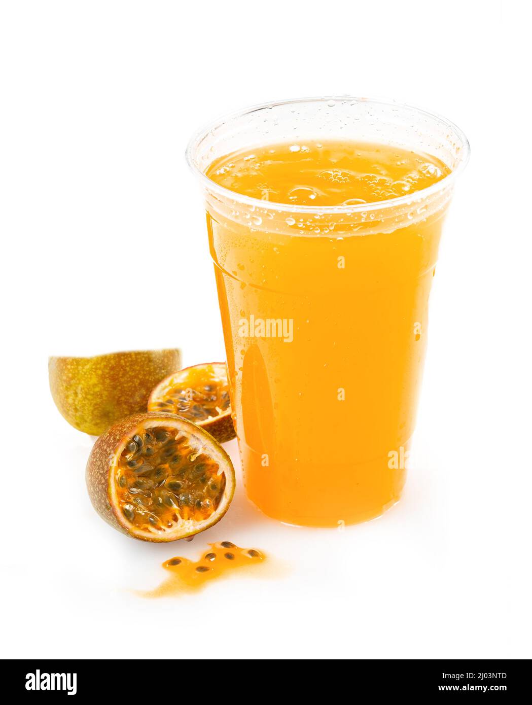 Fresh passion flower juice in a plastic cup on a white background with