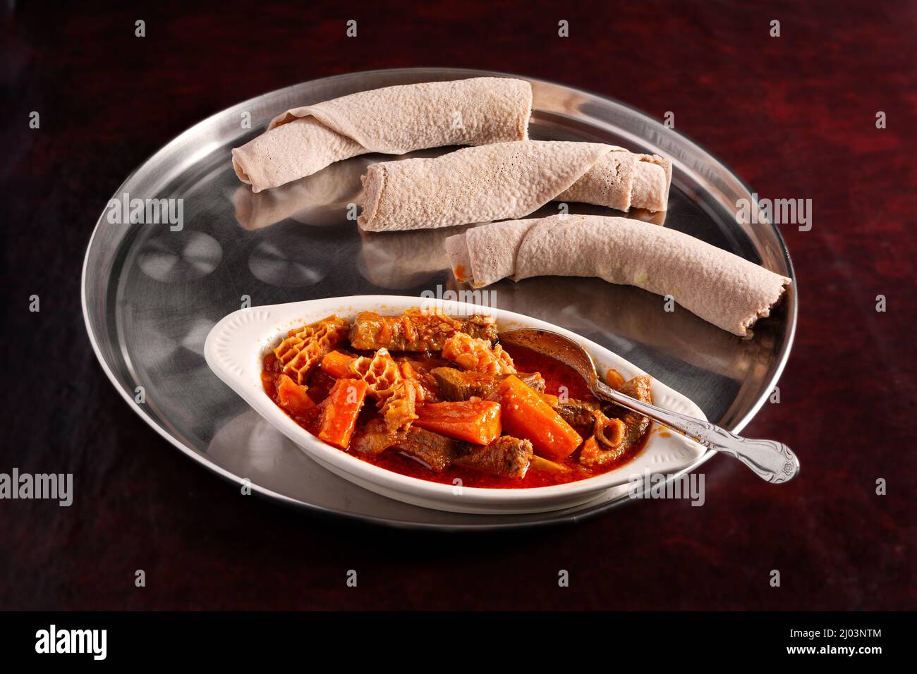 Ethiopian Melas sember with injera bread in a silver platter Stock Photo