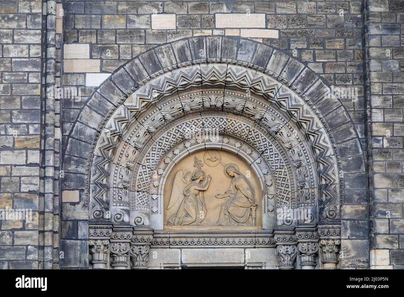 Relief with the Virgin Mary and the angel. Neo-romanesque portal of old Saint Cyril and Methodius Church in Karlin, Prague, Czech Republic.  Stock Photo