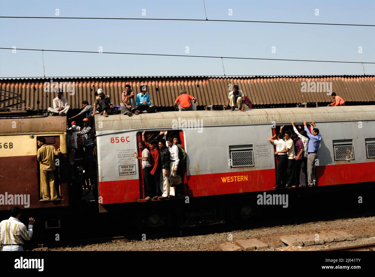 Indian commuters travel on the roof of a train performing stunts on ...