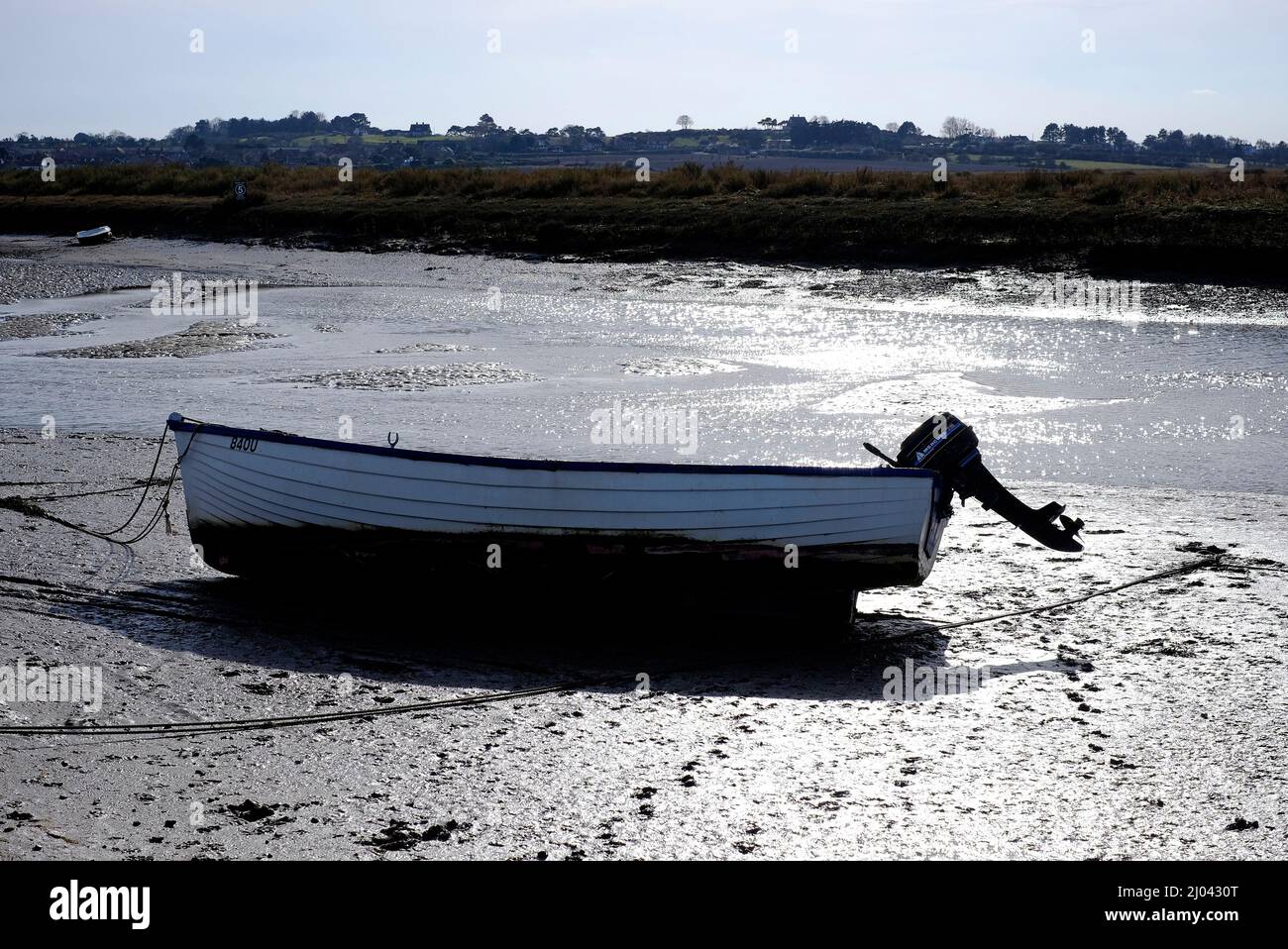 rowing boat with outboard motor, blakeney, north norfolk, england Stock Photo