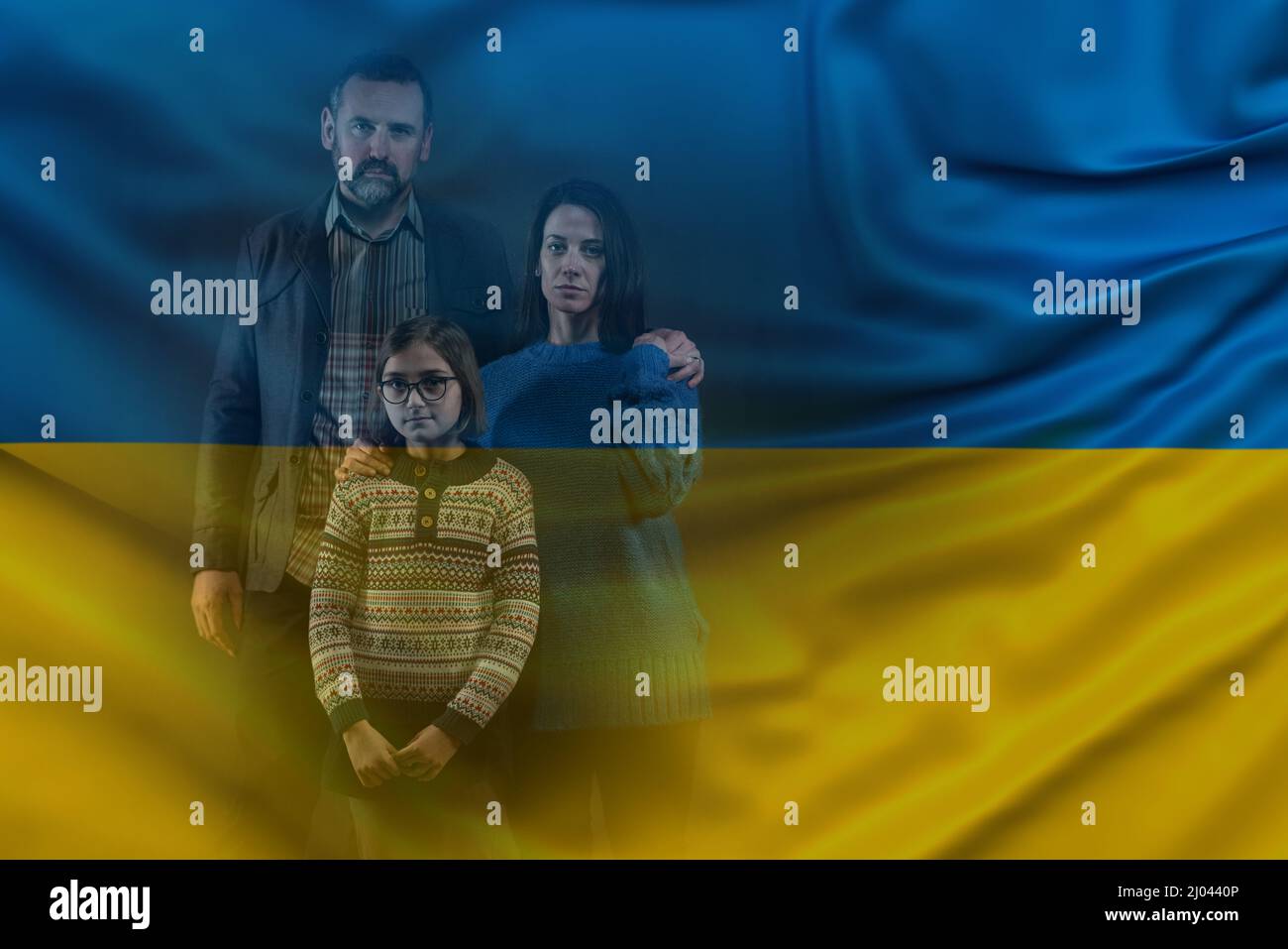 Double exposure of refugee family with one child looking at camera and Ukrainian flag Stock Photo