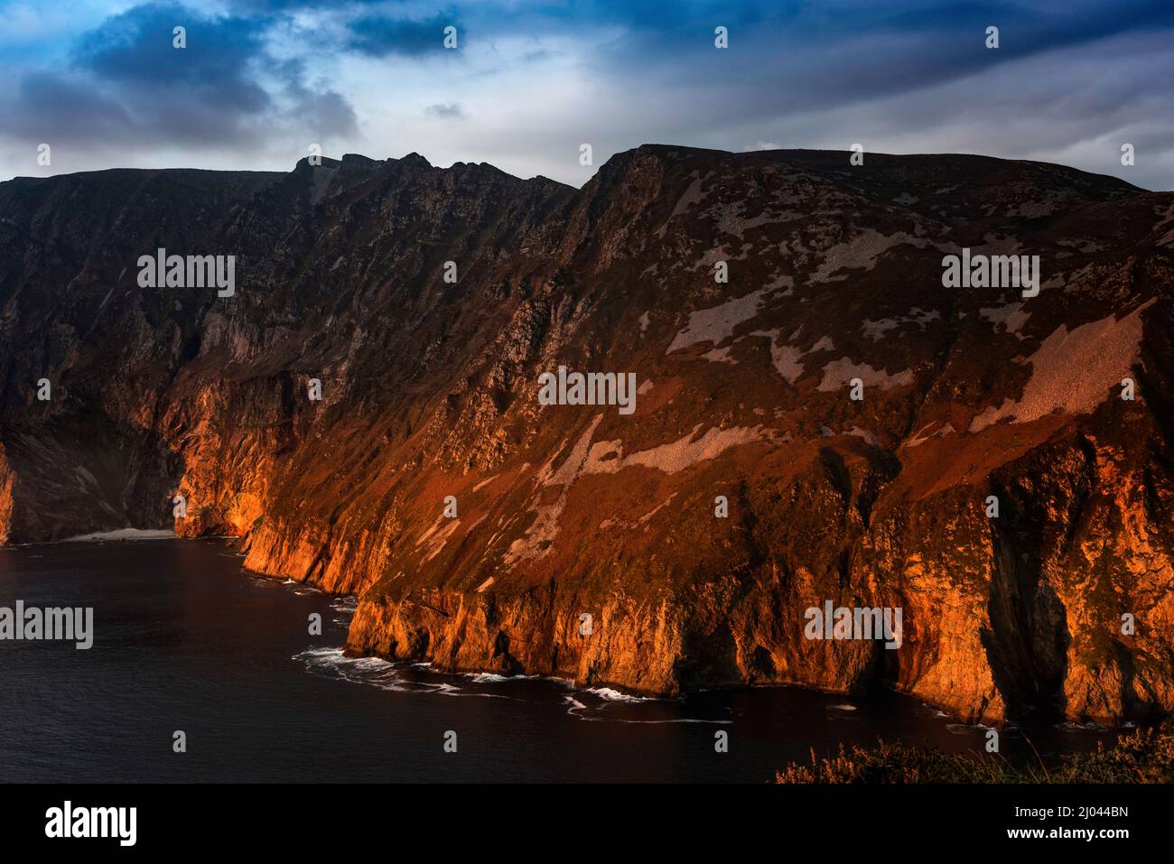 The setting sun lights up the Slieve League or Sliabh Liag Cliffs, County Donegal, Ireland Stock Photo