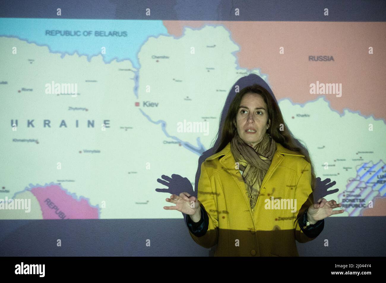 Woman lecturer points at Ukraine on a map of Eastern Europe Stock Photo