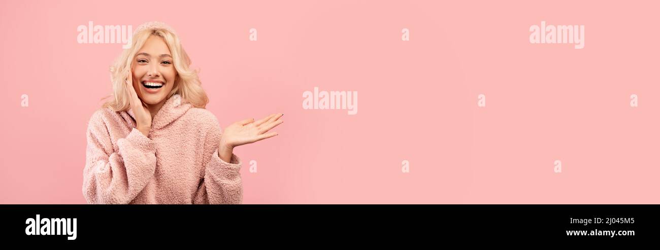 Happy young blonde woman showing copy space Stock Photo