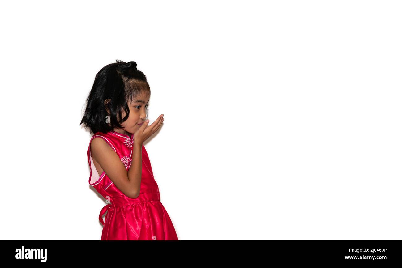 happy, smiling female asian kid playing and flying kiss Blowing hand Stock Photo
