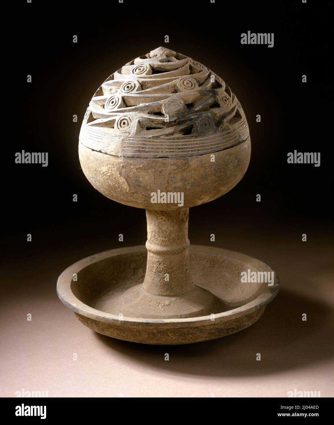 Lidded Incense Burner (Boshanlu) with Cloud Scrolls. China, Eastern Han dynasty, 25-220. Tools and Equipment; burners. Wheel-thrown stoneware with cut and incised decoration Stock Photo