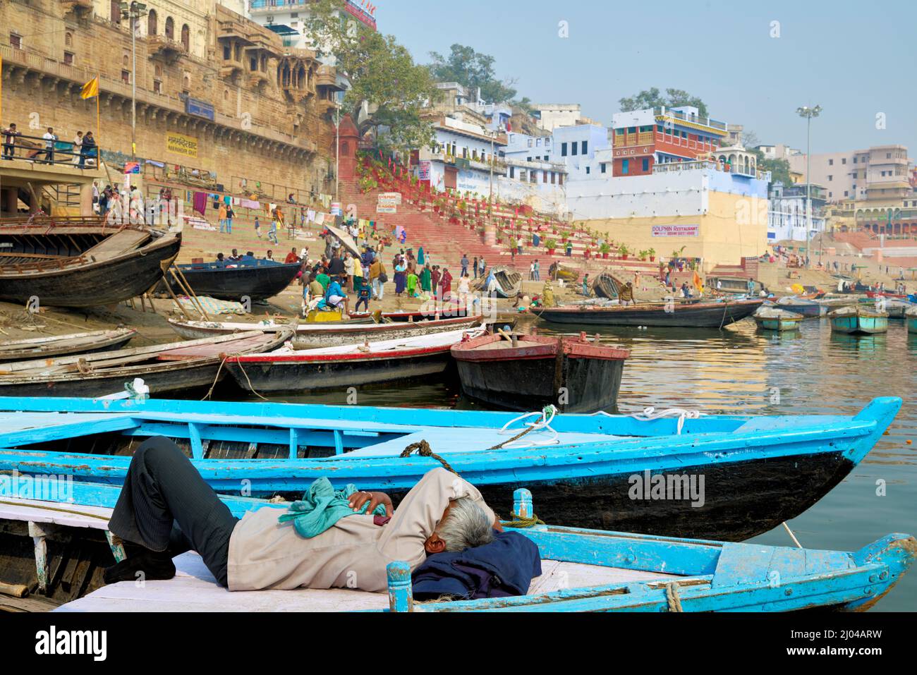India. Varanasi Benares Uttar Pradesh. A man havin a rest on a boat on river Ganges Stock Photo