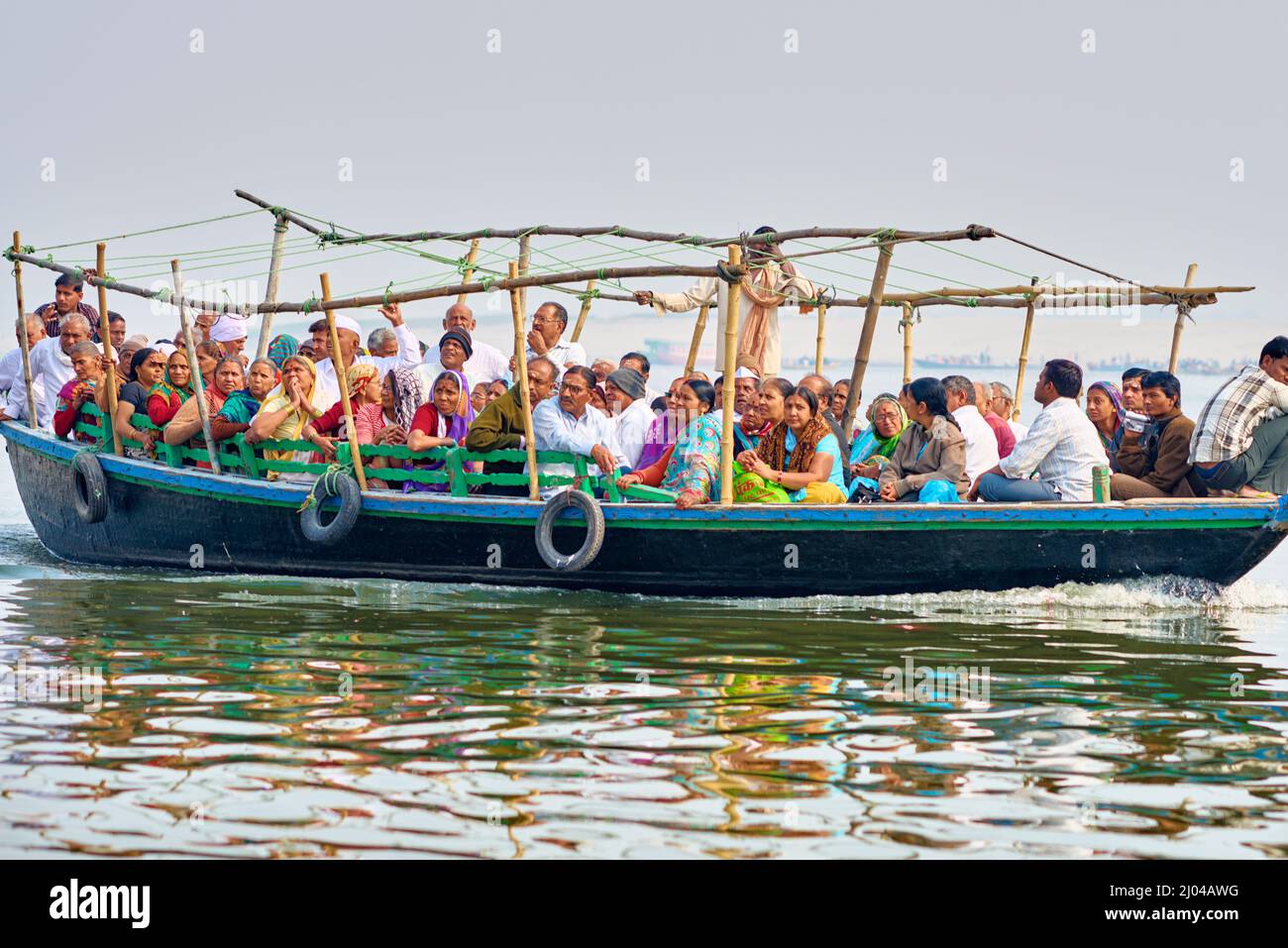 India. Varanasi Benares Uttar Pradesh. Pilgrims on a boat on river Ganges Stock Photo
