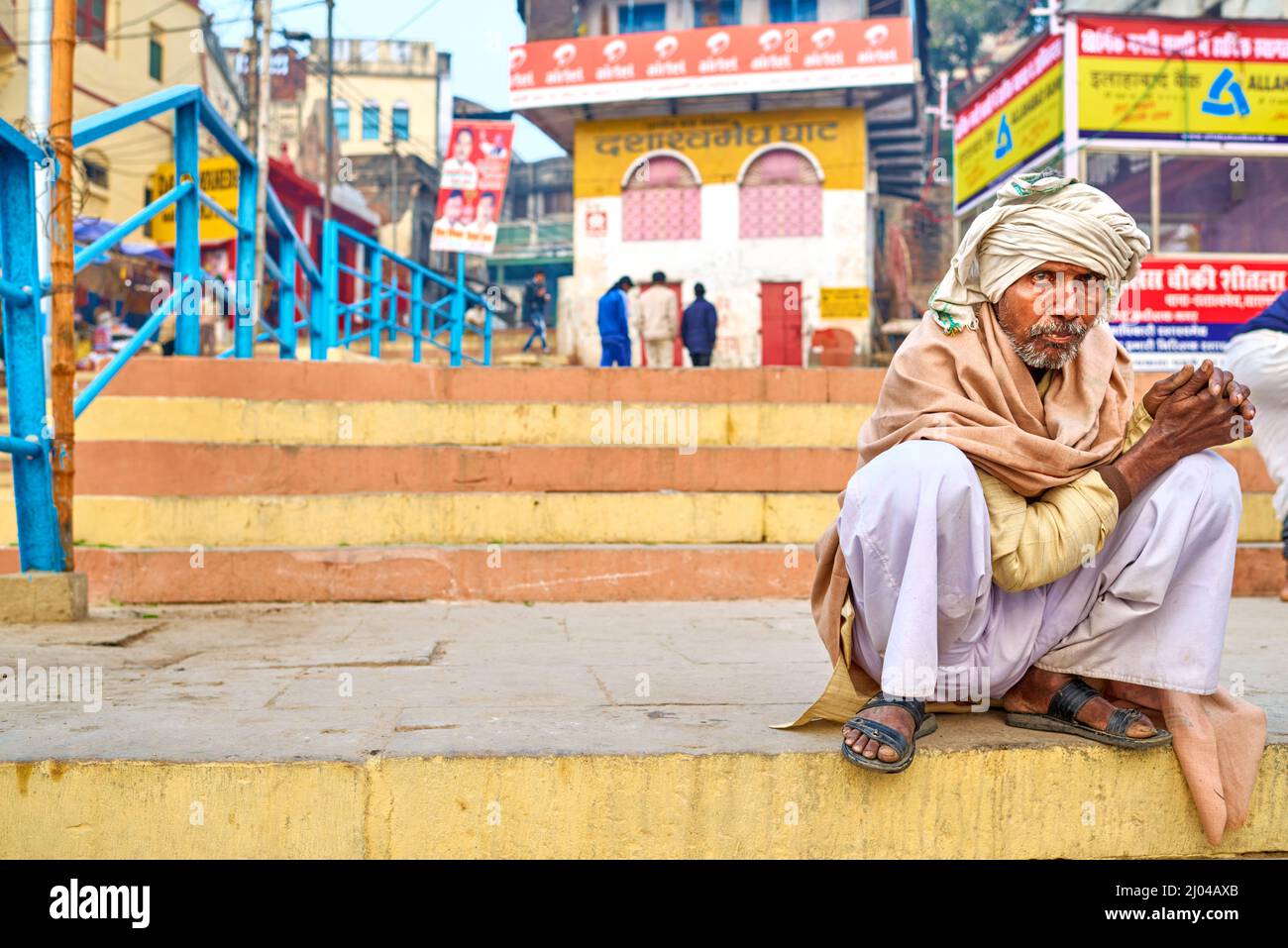 India. Varanasi Benares Uttar Pradesh. Man on a ghat by the river Ganges Stock Photo