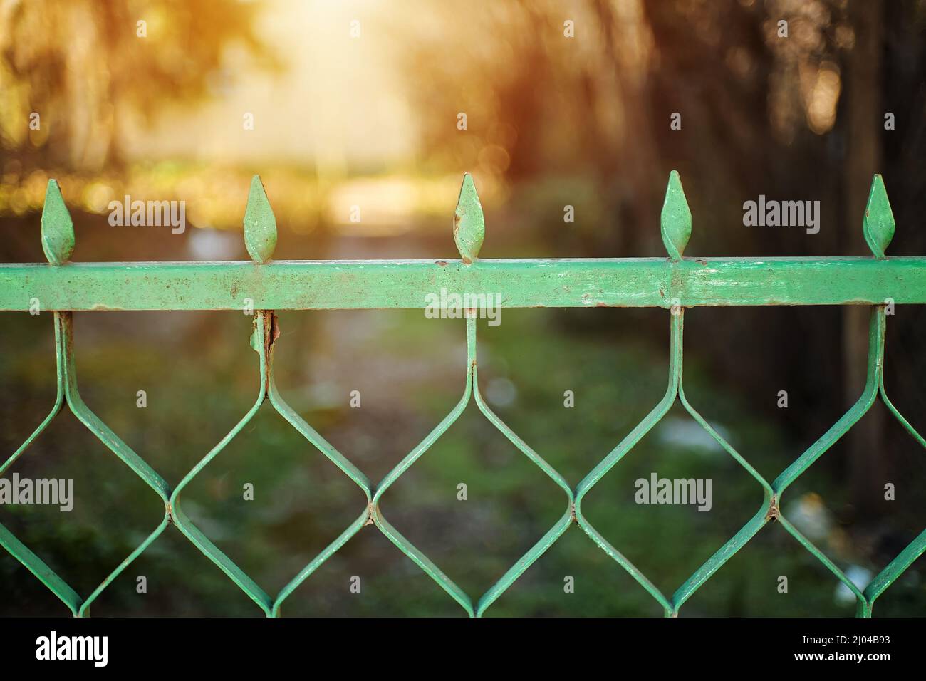 Old vintage metal gate with green chipping paint Stock Photo
