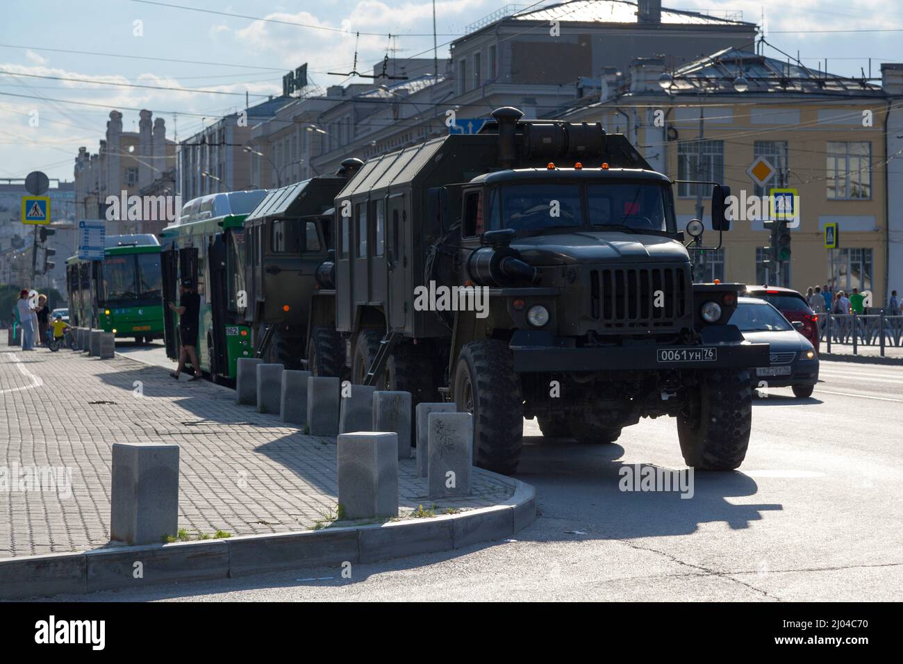 Ekaterinburg, Russia - July 15 2018: Two army trucks parked in the street while the soldiers are playing at a concert outside of the Church of Maximil Stock Photo