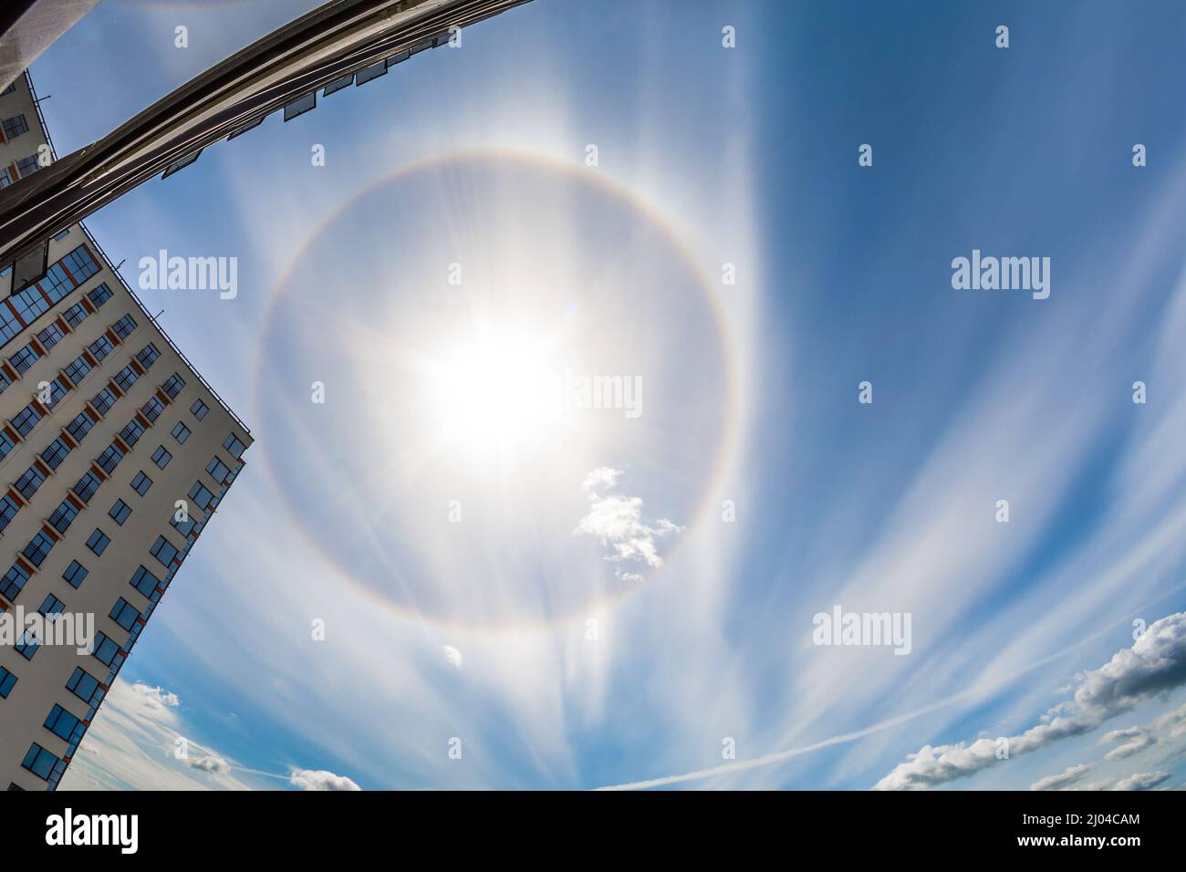 Halo sun in the clouds of cirrus on the city Stock Photo