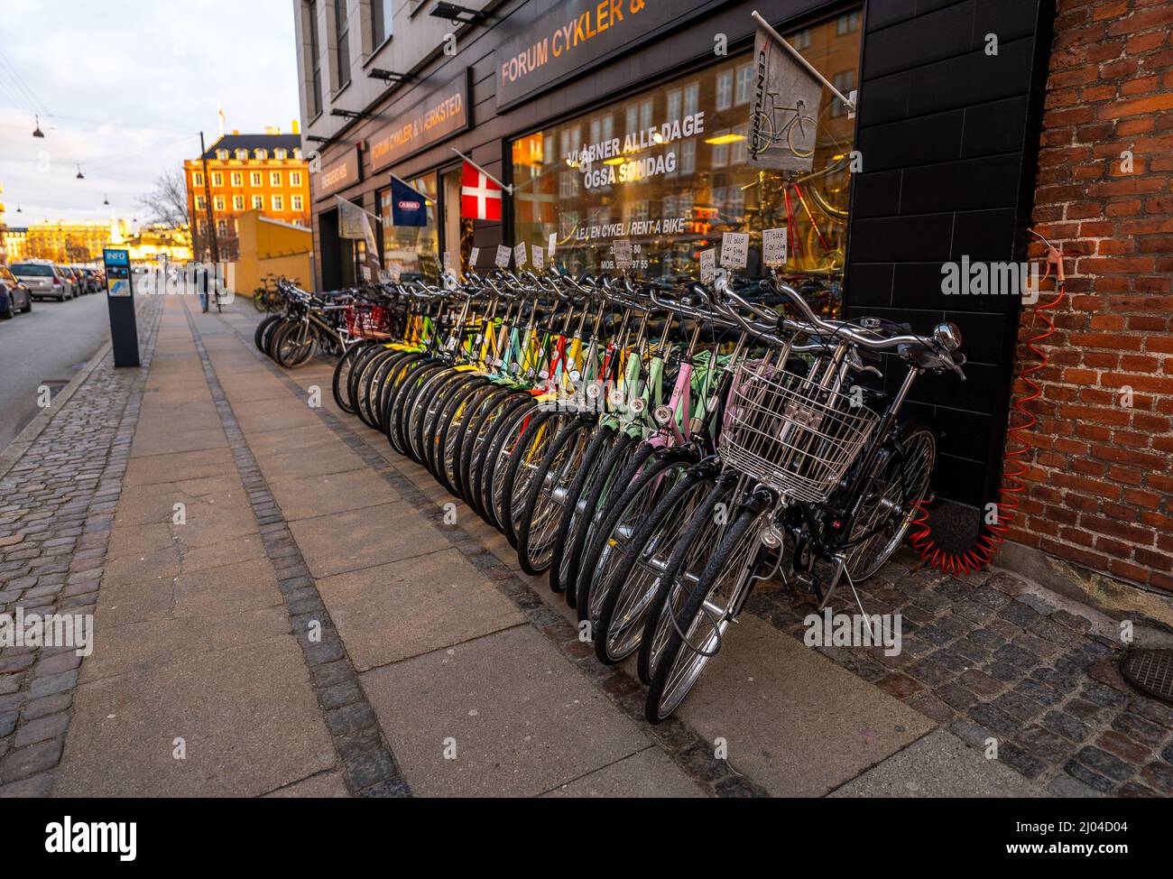 Parked bicycles for rent on sidewalk in Copenhagen, Denmark Stock Photo