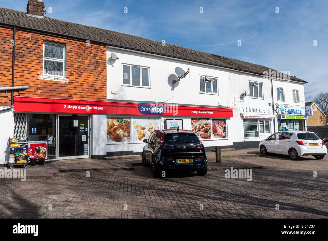 Row of local shops in Oakley village in Hampshire, England, UK Stock