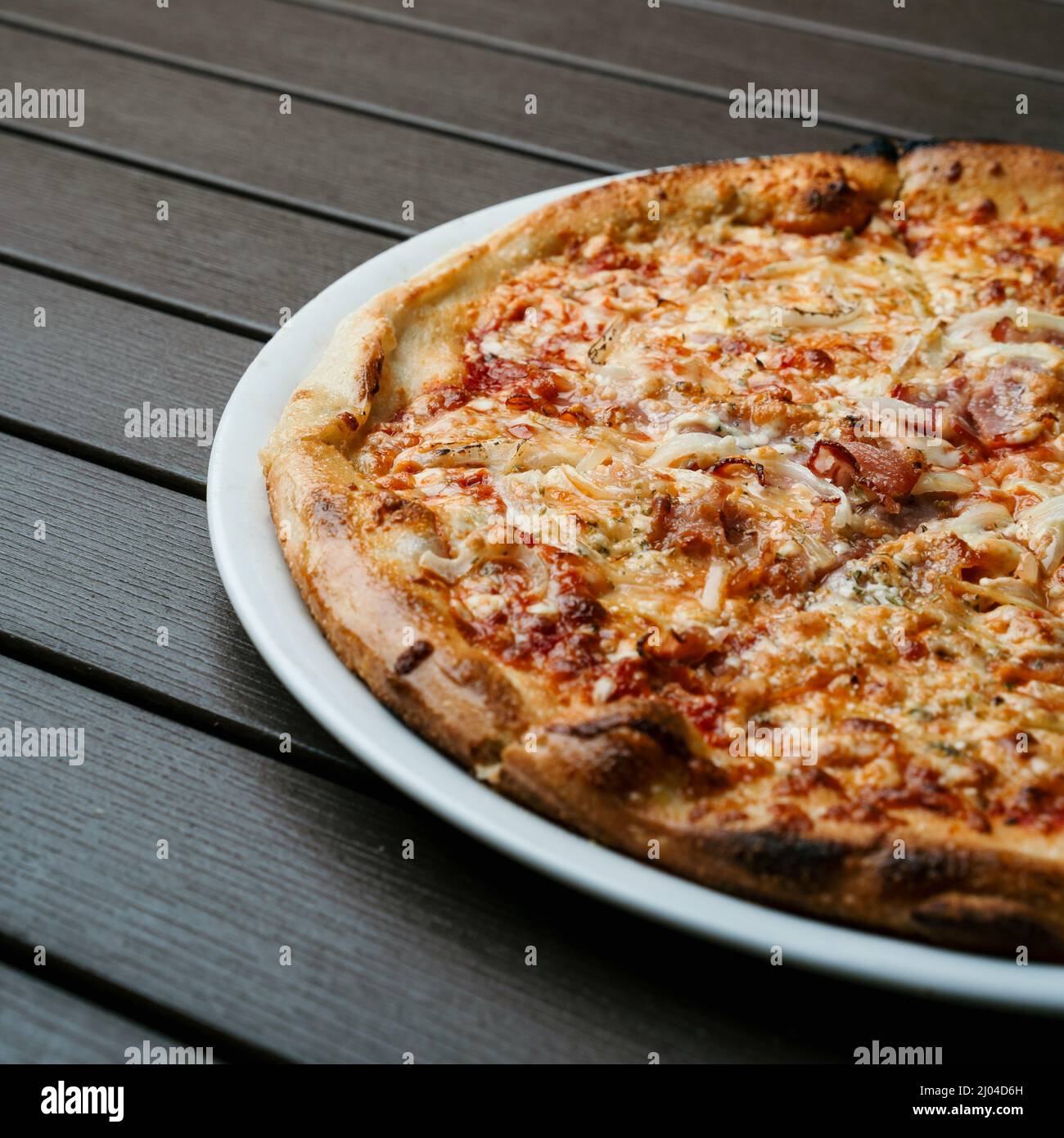 Serving of delicious fresh Italian pizza with meat and cheese Stock