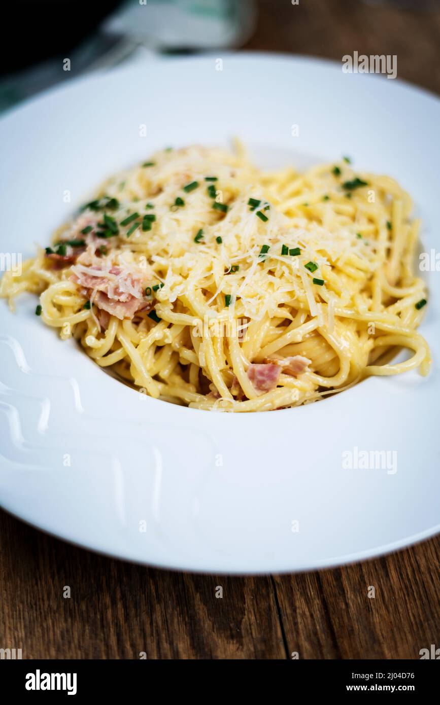 Italian cuisine pasta spaghetti ala carbora with egg, cheese parmasan and bacon Stock Photo