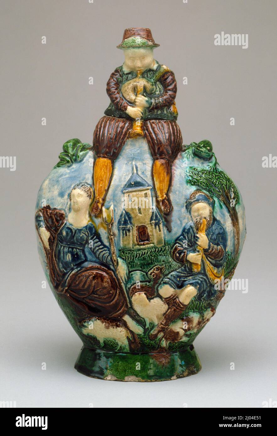 Flask with a Seated Bagpiper. Palissy (after), Bernard (France, 1509–1590). France, circa 1560-1600. Tools and Equipment; flasks. Lead-glazed earthenware, Palissy ware Stock Photo
