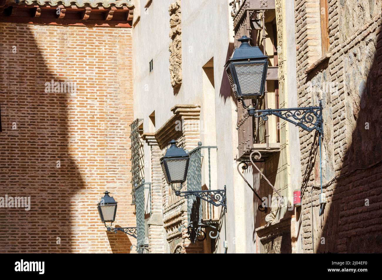 Ornamental street lanterns on beautiful decorative walls in Toledo, Spain Stock Photo