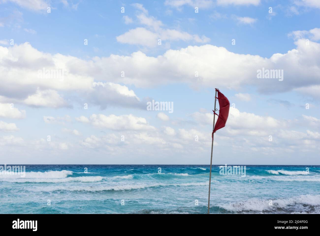 Red flag at Cancun beach Stock Photo Alamy