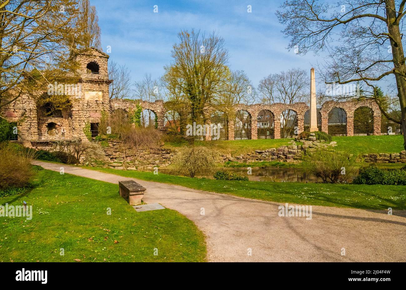 Lovely scenic view of the artificial ruins of a Roman water fort with an attached aqueduct built by Nicolas de Pigage in the English landscape garden... Stock Photo
