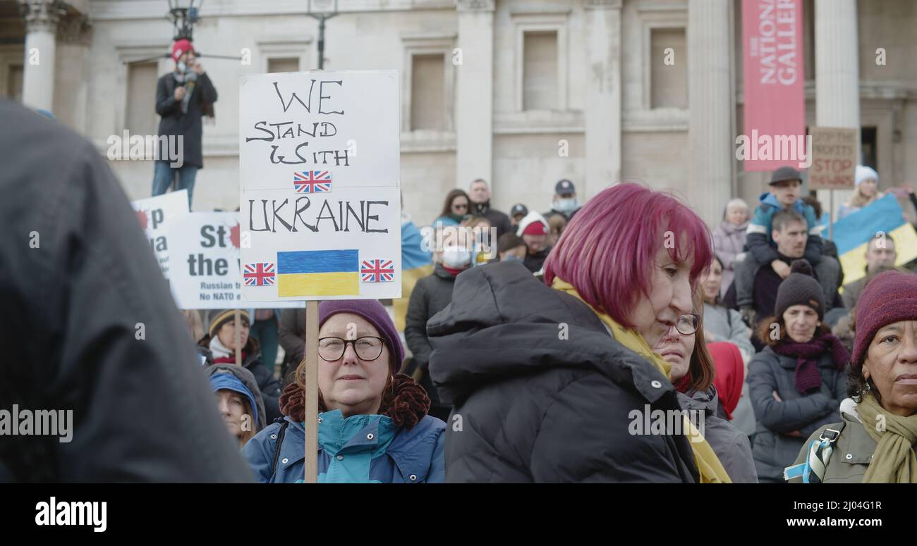 London, UK - 03 06 2022:  A woman protester at Trafalgar Square holding a sign, ‘We Stand With Ukraine’, showing UK support for Ukrainian people . Stock Photo