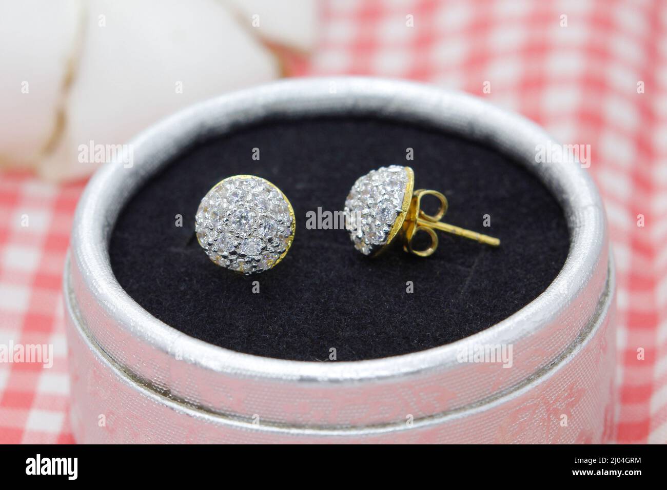 Beautiful golden earrings decorated with diamond display in jewelry box