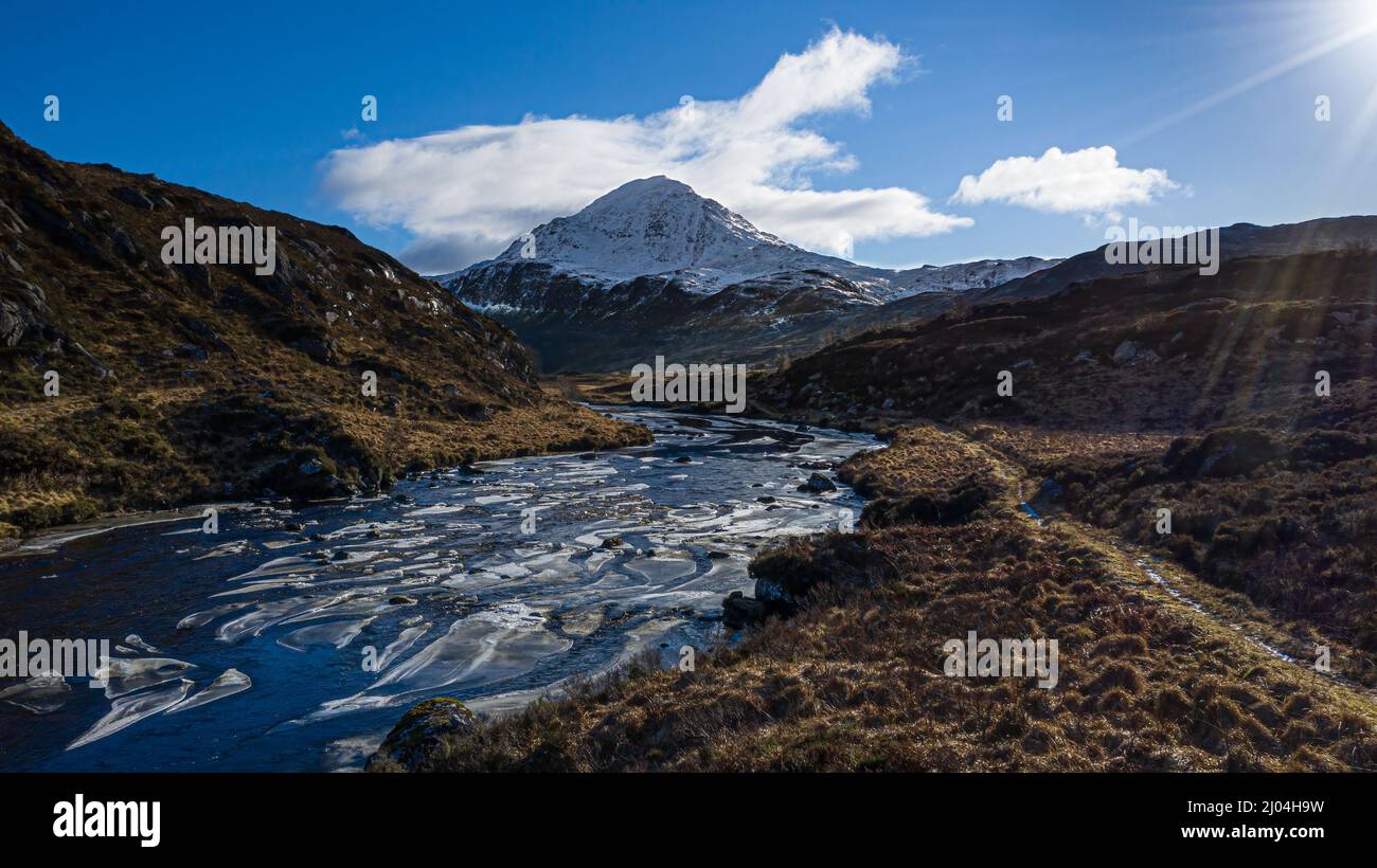 Icey River Laxford leading towards a snow covered Ben Stack in Winter. Highland, Scotland. Stock Photo