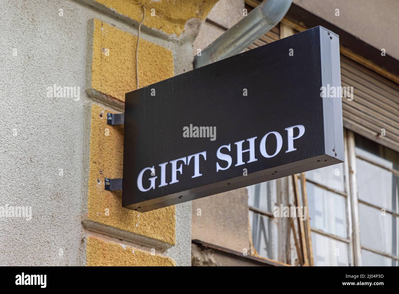 Black Sign With White Letters Gift Shop at Wall Stock Photo