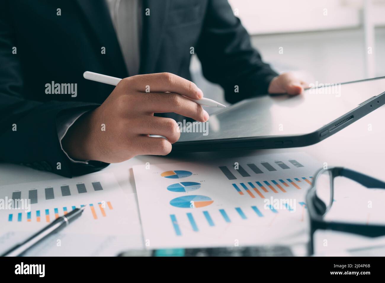 Closeup businessman hand using tablet computer at work Stock Photo