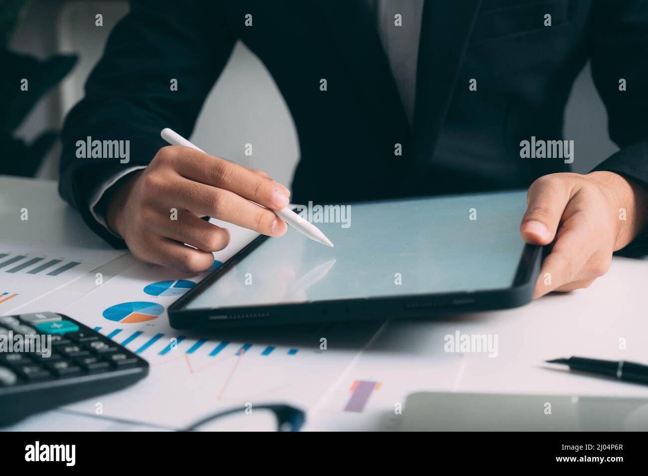 Closeup businessman hand using tablet computer at work Stock Photo
