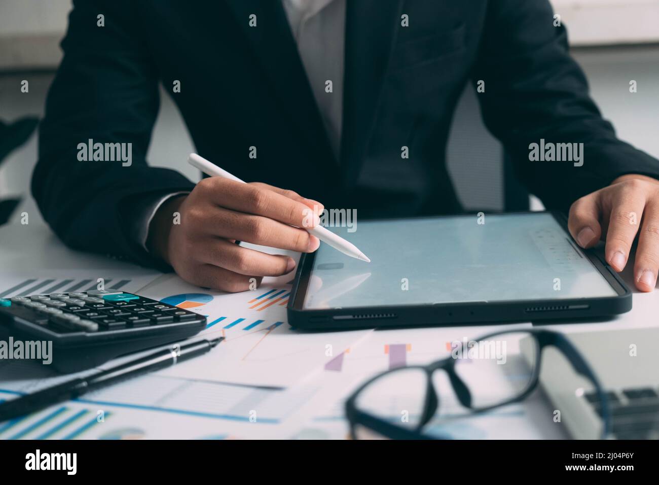 Closeup businessman hand using tablet computer at work Stock Photo