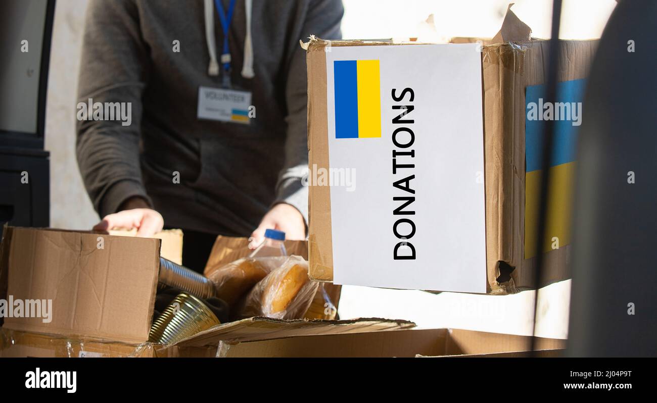 Box with donation clothes and food for ukrainian refugees suffering