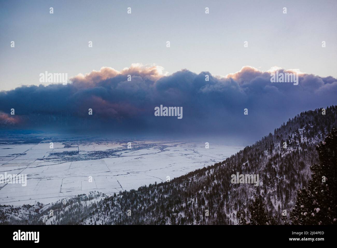 Dark Blue Clouds, Mountain, and Valley with Rising Light Stock Photo ...