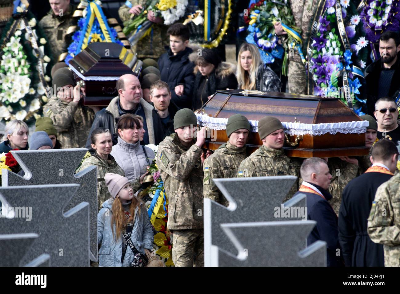 Lviv, Ukraine, 16/03/2022, Ukrainian soldiers carry coffins with the bodies of servicemen of the National Hetman Petro Sahaidachnyi Land Forces Academy who died as a result of shelling of the International Center for Peacekeeping and Security (Yavoriv proving ground). The defenders of Ukraine are buried with all military honors at the Lychakiv Cemetery, in Lviv, western Ukraine, on March 15, 2022. Photo by Markiian Lyseiko/Ukrinform/ABACAPRESS.COM Stock Photo
