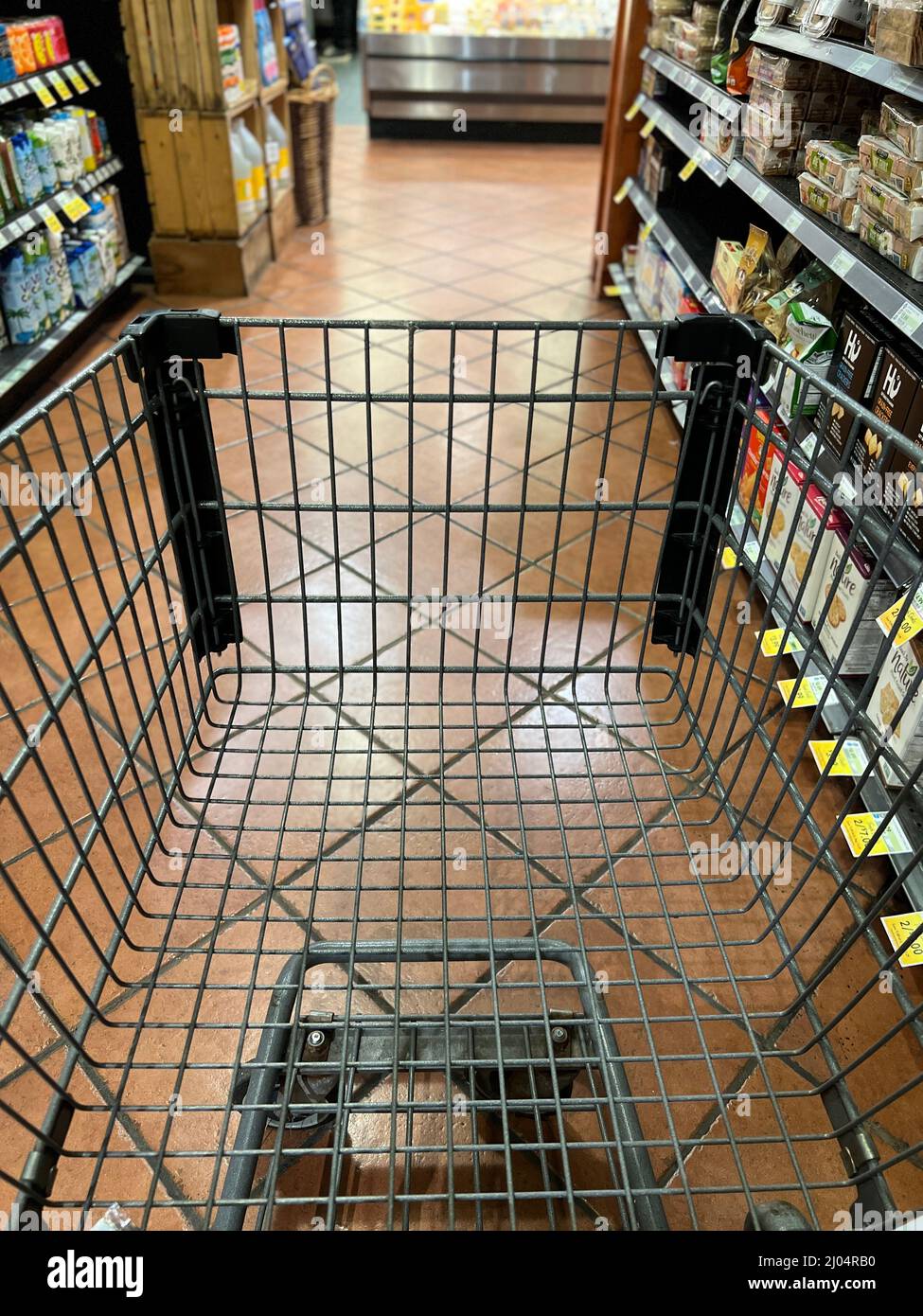 Grocery cart on a shopping trip going through the aisles Stock Photo