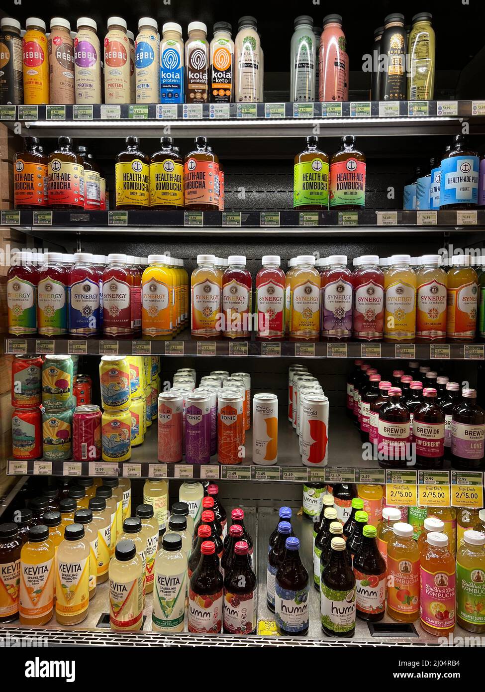 Cooler filled with a variety of kombucha brands and flavors in The Fresh Market store. Stock Photo
