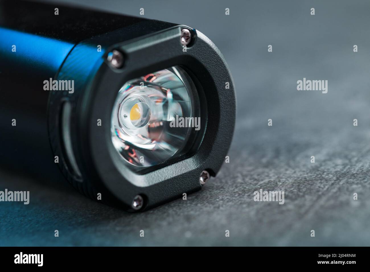 Black Rechargeable Flashlight handheld, LED close-up on a black background Stock Photo