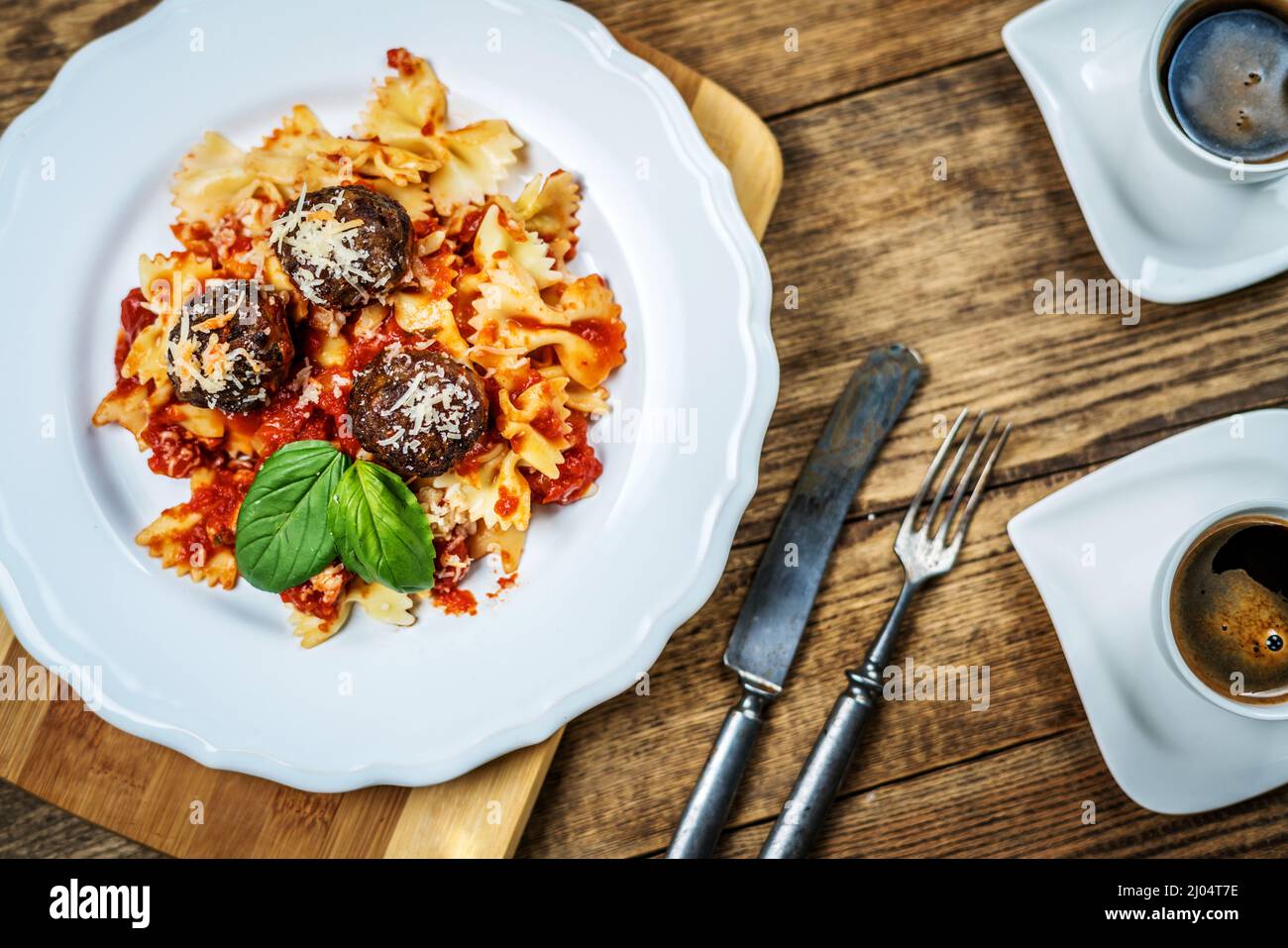 Italian meat balls with tomato sauce, basil and pasta Stock Photo Alamy