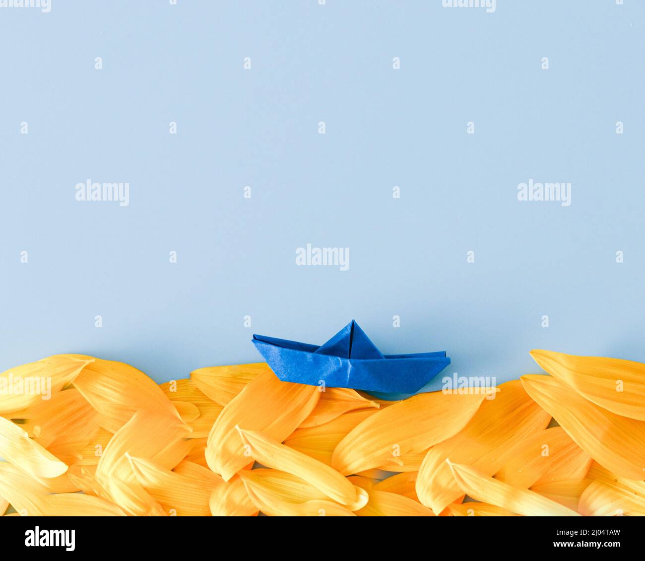yellow-blue ukrainian colors sea with paper blue boat Stock Photo
