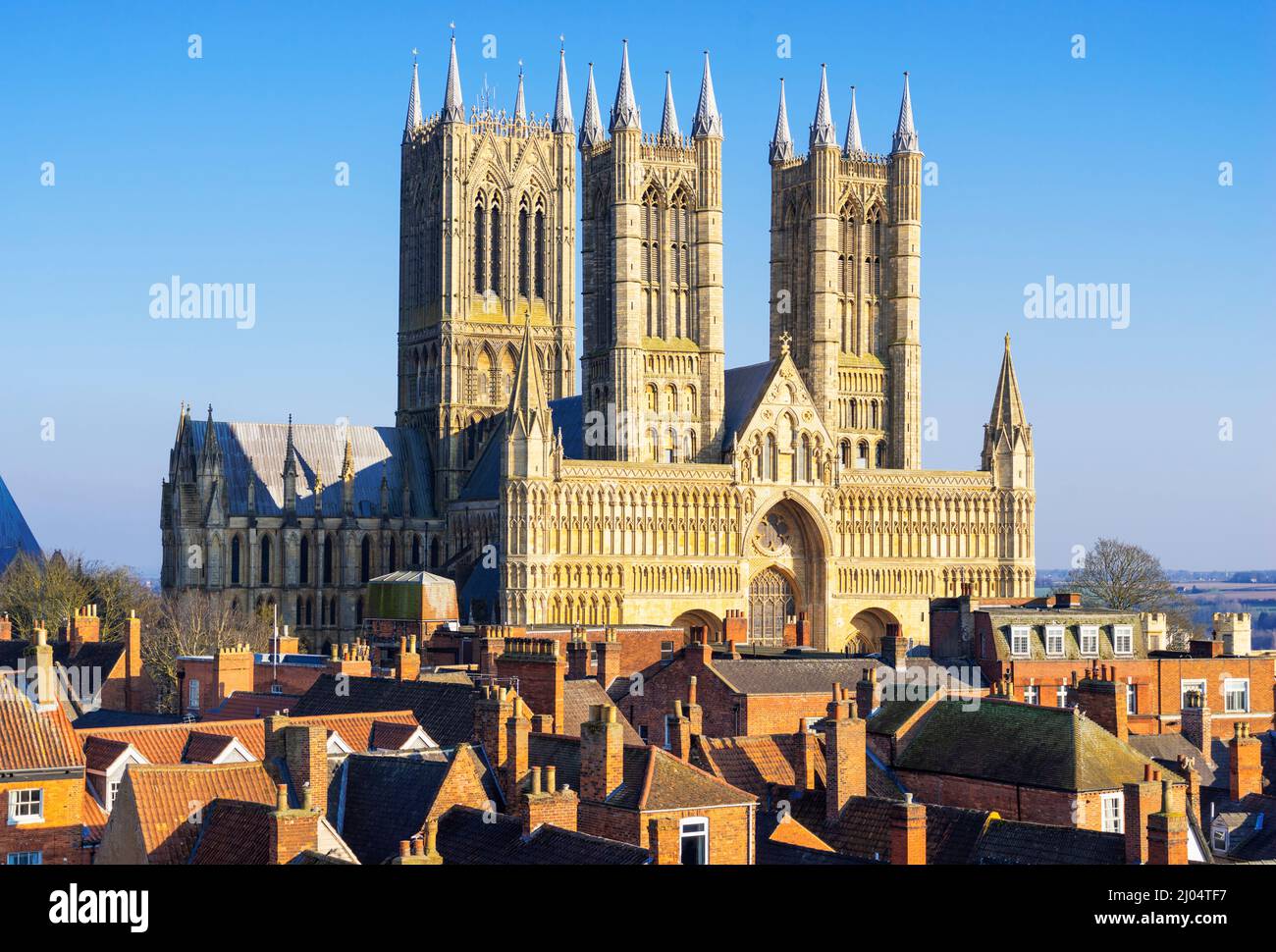Lincoln Cathedral or Lincoln Minster behind the rooftops of the City of Lincoln Lincolnshire England UK GB Europe Stock Photo