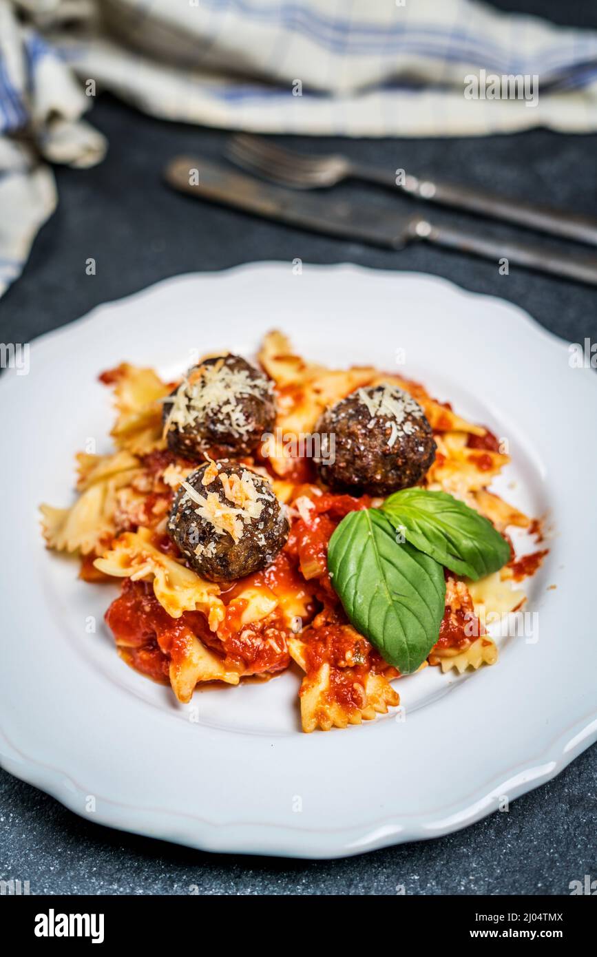 Italian meat balls with tomato sauce, basil and pasta Stock Photo