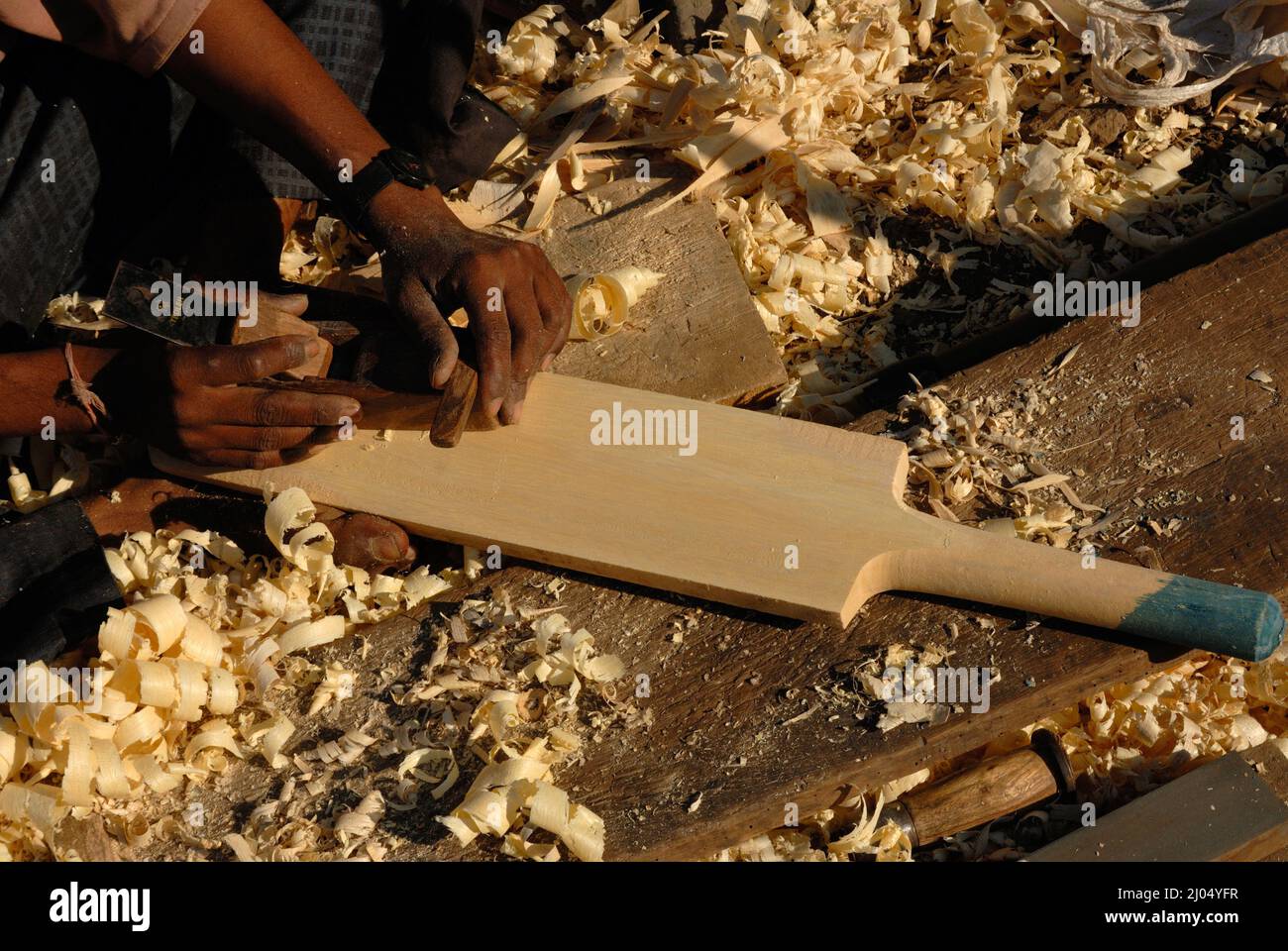 Nashik, Maharashtra, India, Asia, Dec. 09, 2006 - Indian man carpanter making A generic wooden cricket bat in work shop Stock Photo